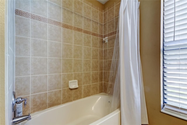 bathroom featuring shower / bath combo with shower curtain