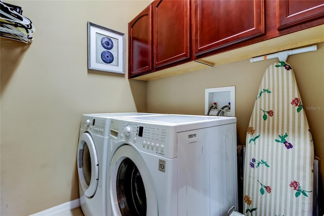 laundry area featuring washer and clothes dryer and cabinet space