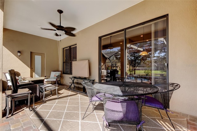 view of patio with outdoor dining space and ceiling fan