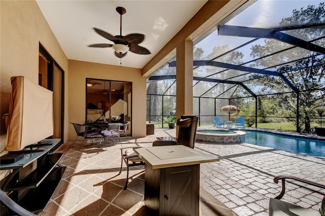 exterior space featuring a lanai, a pool with connected hot tub, and ceiling fan