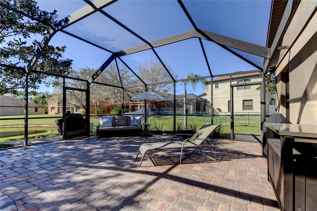 view of patio / terrace featuring glass enclosure, an outdoor living space, and a residential view