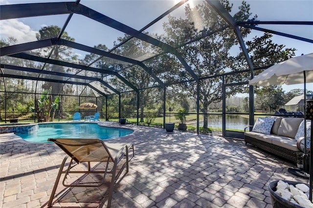 view of pool featuring glass enclosure, a patio, and a pool with connected hot tub