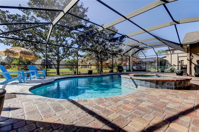 view of pool with a patio area, a pool with connected hot tub, and a lanai