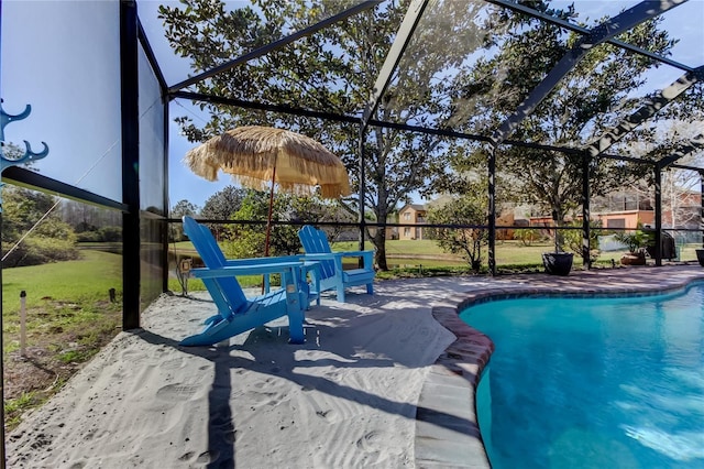 outdoor pool with glass enclosure and a patio area