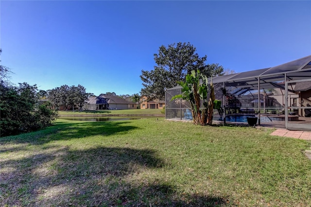 view of yard with glass enclosure and an outdoor pool