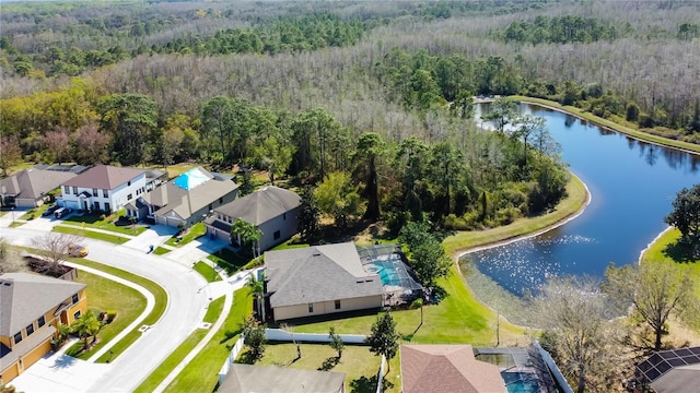 birds eye view of property featuring a residential view, a forest view, and a water view