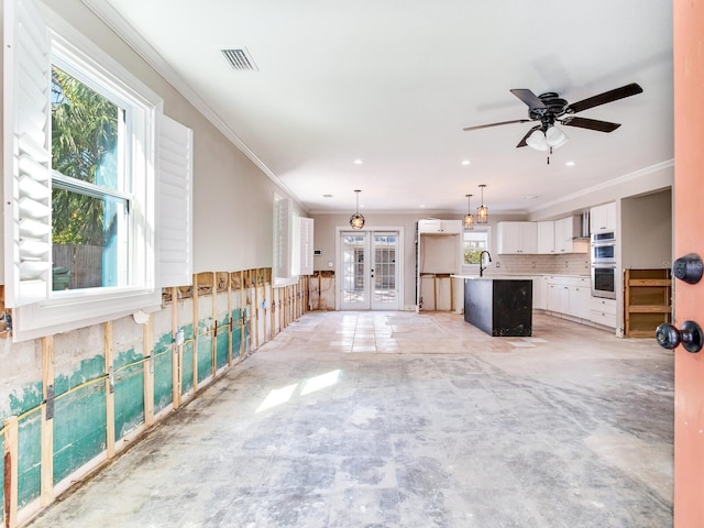 unfurnished living room with visible vents, recessed lighting, and crown molding