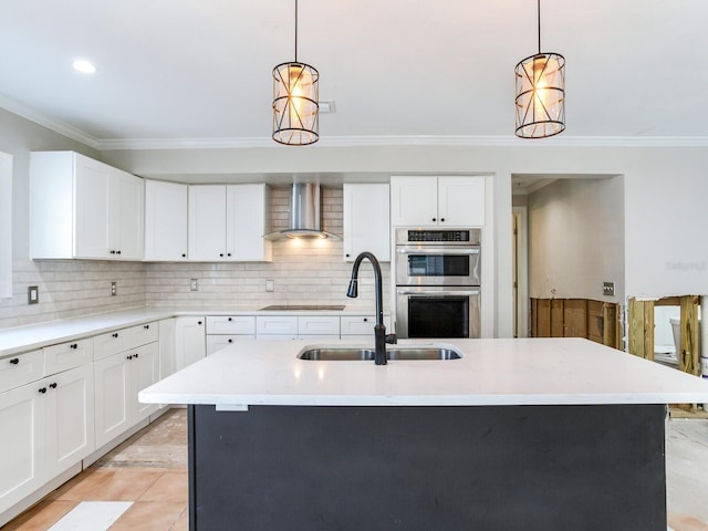 kitchen with double oven, crown molding, wall chimney range hood, and a sink