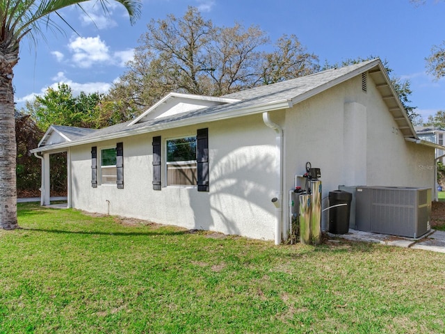 view of home's exterior featuring stucco siding, cooling unit, and a yard