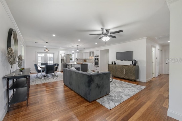 living room featuring baseboards, ornamental molding, and dark wood-style flooring