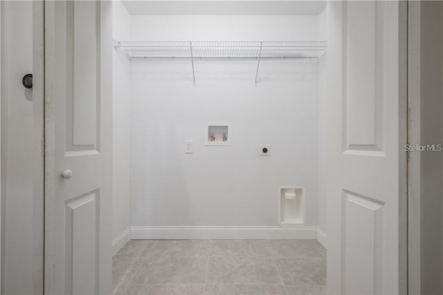 laundry area with washer hookup, light tile patterned flooring, baseboards, hookup for an electric dryer, and laundry area