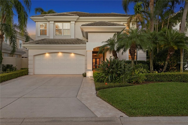 926 Anchorage Rd, Tampa, FL 33602 - view of front of home featuring a tile roof, concrete driveway, stucco siding, a yard, and an attached garage