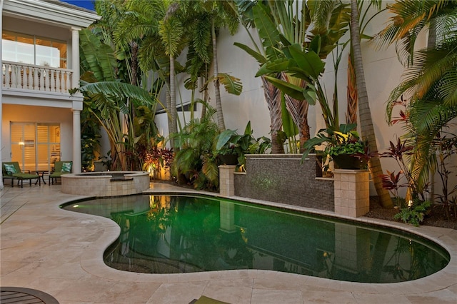 pool featuring a patio area and an in ground hot tub