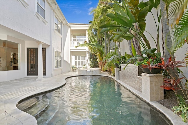 view of swimming pool featuring a patio and a pool with connected hot tub