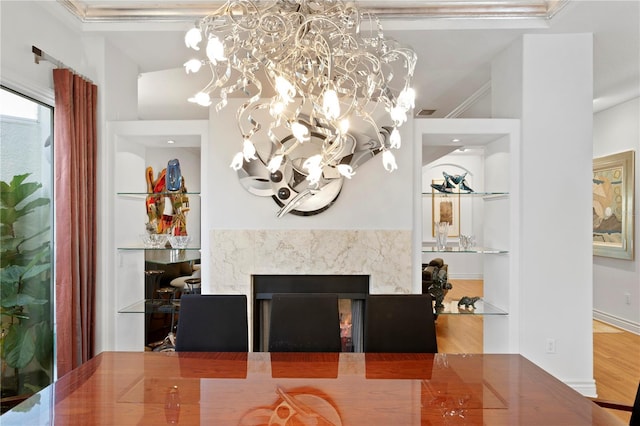 dining area with a chandelier, a fireplace, and wood finished floors