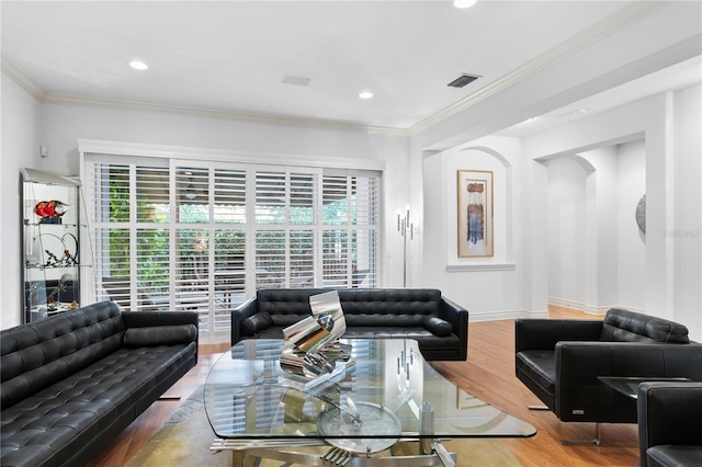 living area with crown molding, recessed lighting, wood finished floors, and visible vents