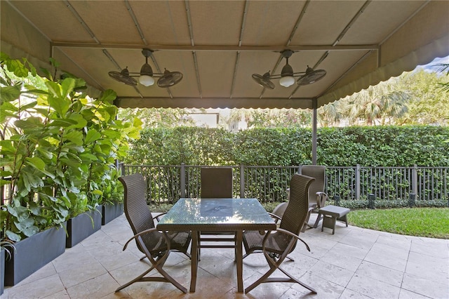 view of patio / terrace with outdoor dining space, a ceiling fan, and fence