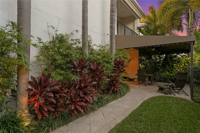 yard at dusk with a patio