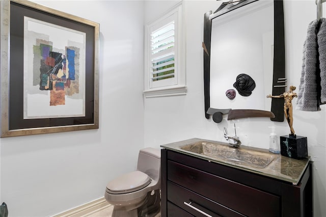 half bathroom with toilet and vanity