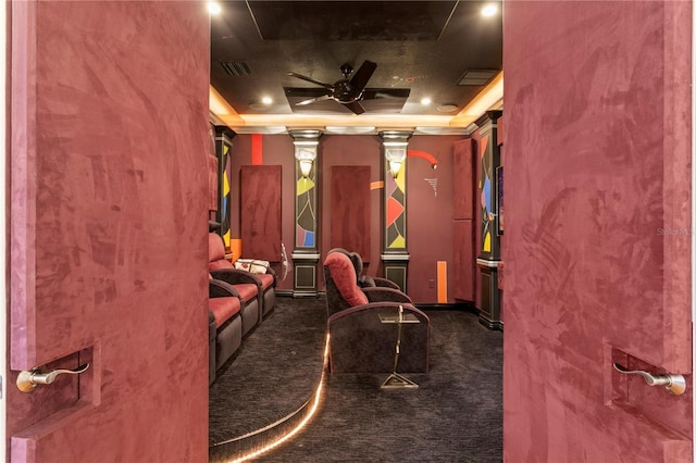 home theater featuring carpet flooring, visible vents, a ceiling fan, and a tray ceiling