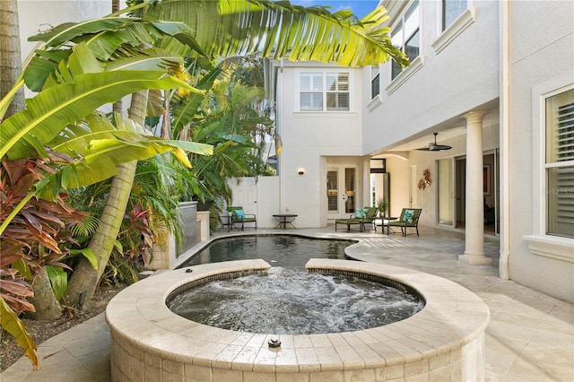 view of swimming pool featuring an in ground hot tub and a patio area