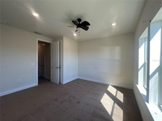 spare room with visible vents, baseboards, and carpet floors