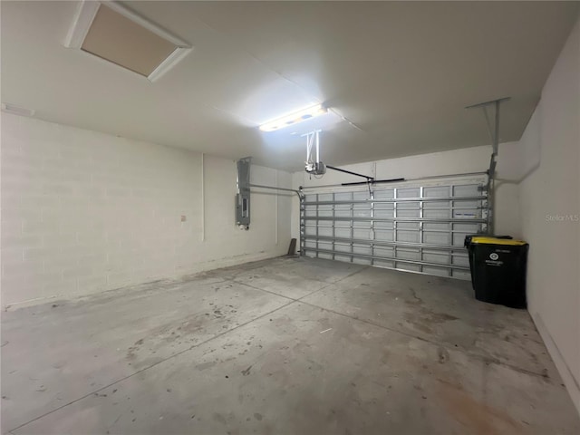 garage featuring electric panel and a garage door opener