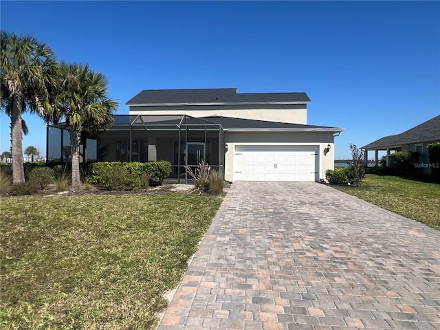 view of front facade with glass enclosure, stucco siding, a front lawn, a garage, and decorative driveway