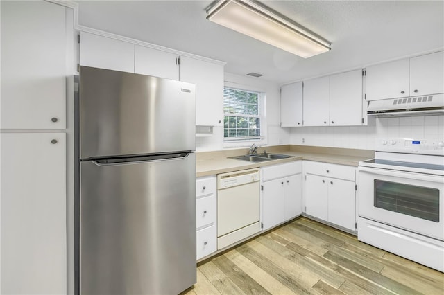 kitchen featuring white appliances, light wood finished floors, a sink, white cabinets, and under cabinet range hood