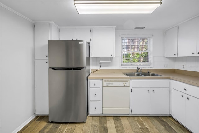 kitchen with a sink, light wood finished floors, white dishwasher, and freestanding refrigerator