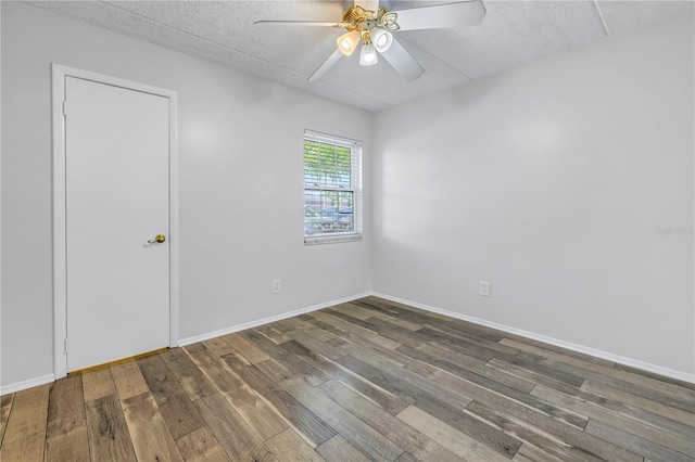 unfurnished room with baseboards, a textured ceiling, ceiling fan, and wood finished floors