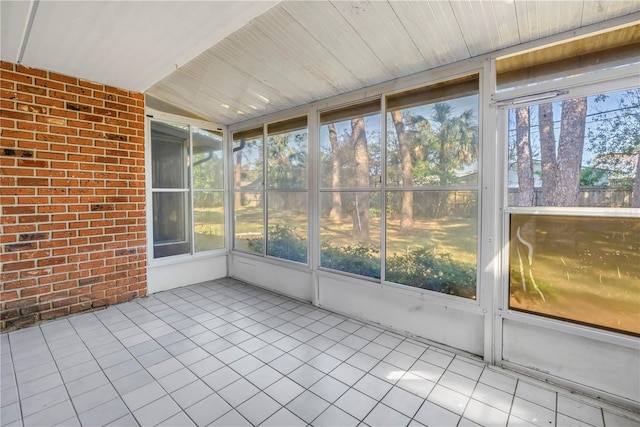 unfurnished sunroom featuring wood ceiling and vaulted ceiling