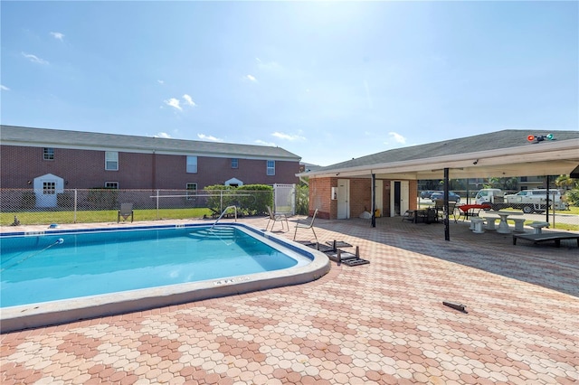 pool featuring a patio and fence