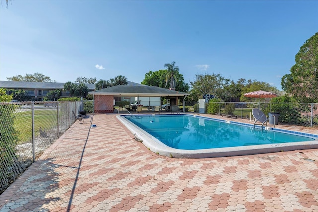 community pool featuring a patio and fence