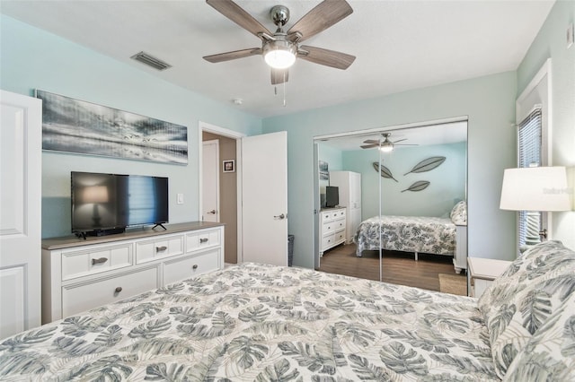 bedroom featuring a closet, visible vents, wood finished floors, and a ceiling fan