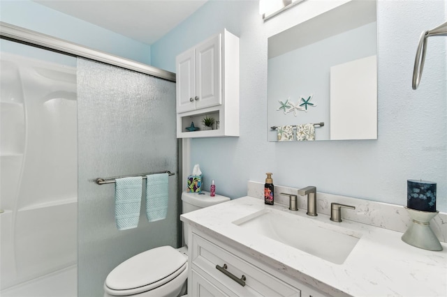 full bathroom featuring vanity, toilet, and a stall shower