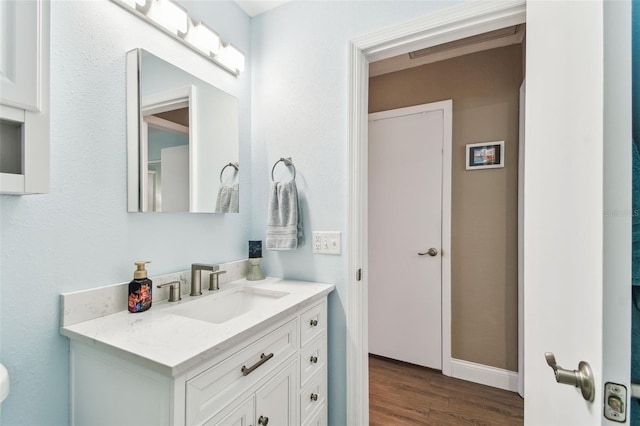 bathroom featuring wood finished floors and vanity