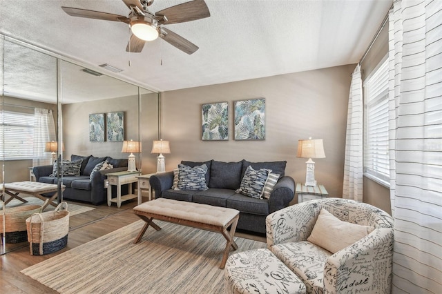 8220 112th St N Unit 206, Seminole, FL 33772 - living room with ceiling fan, a textured ceiling, and wood finished floors