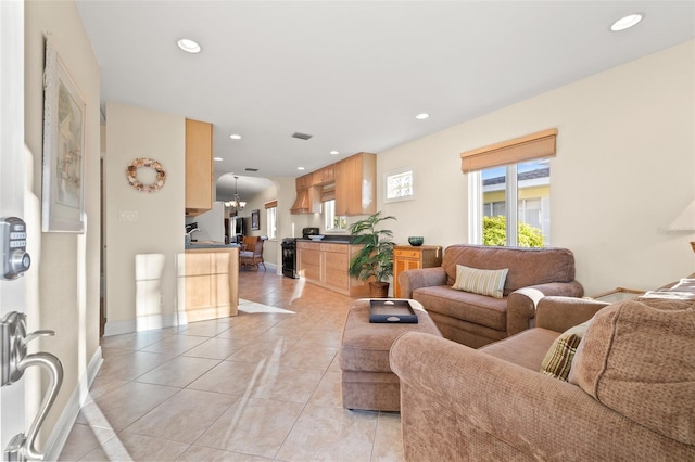 living area featuring light tile patterned floors, recessed lighting, and baseboards