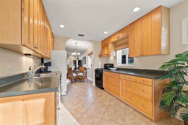 kitchen featuring black gas stove, dark countertops, custom exhaust hood, and a sink