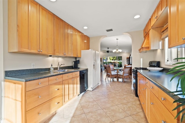 kitchen featuring visible vents, arched walkways, a sink, black appliances, and dark countertops