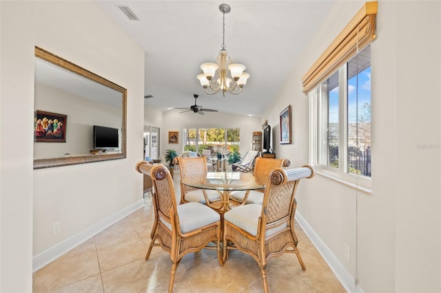 dining space featuring visible vents, ceiling fan with notable chandelier, light tile patterned floors, baseboards, and vaulted ceiling