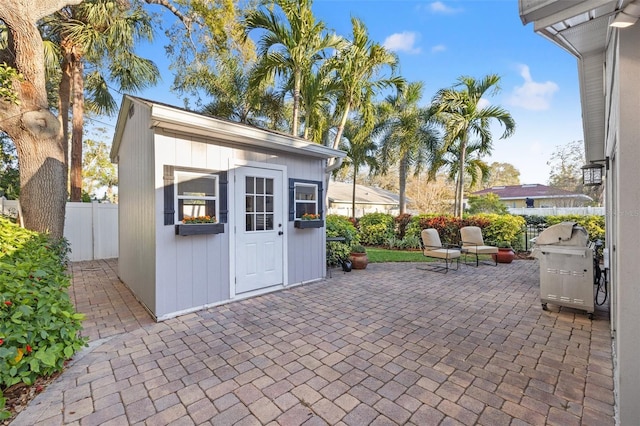 view of outdoor structure with an outbuilding and fence