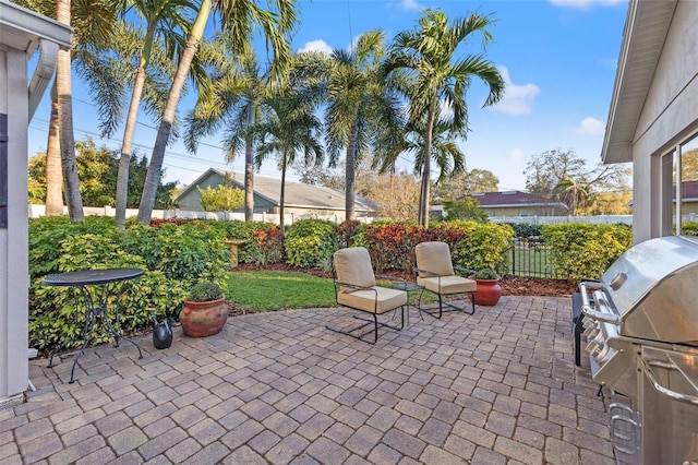 view of patio with grilling area and fence