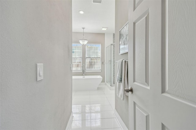 corridor with light tile patterned floors and visible vents