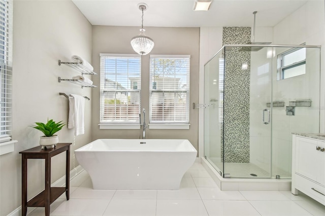 full bath with tile patterned floors, a freestanding tub, a stall shower, baseboards, and vanity