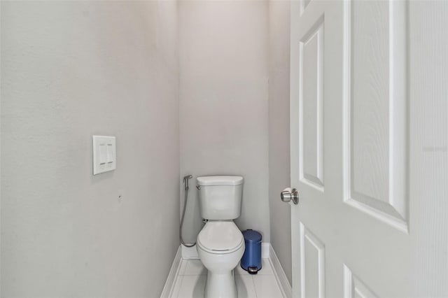 bathroom featuring tile patterned flooring, toilet, and baseboards