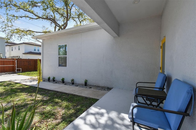 exterior space featuring fence and stucco siding