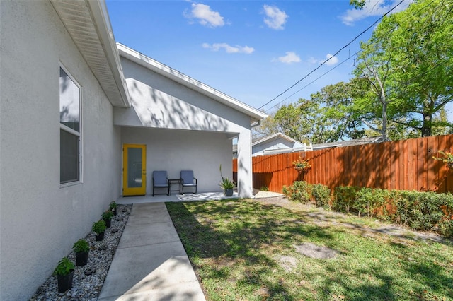 view of yard featuring a patio area and fence