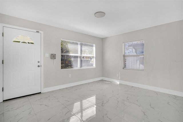 entryway featuring baseboards and marble finish floor